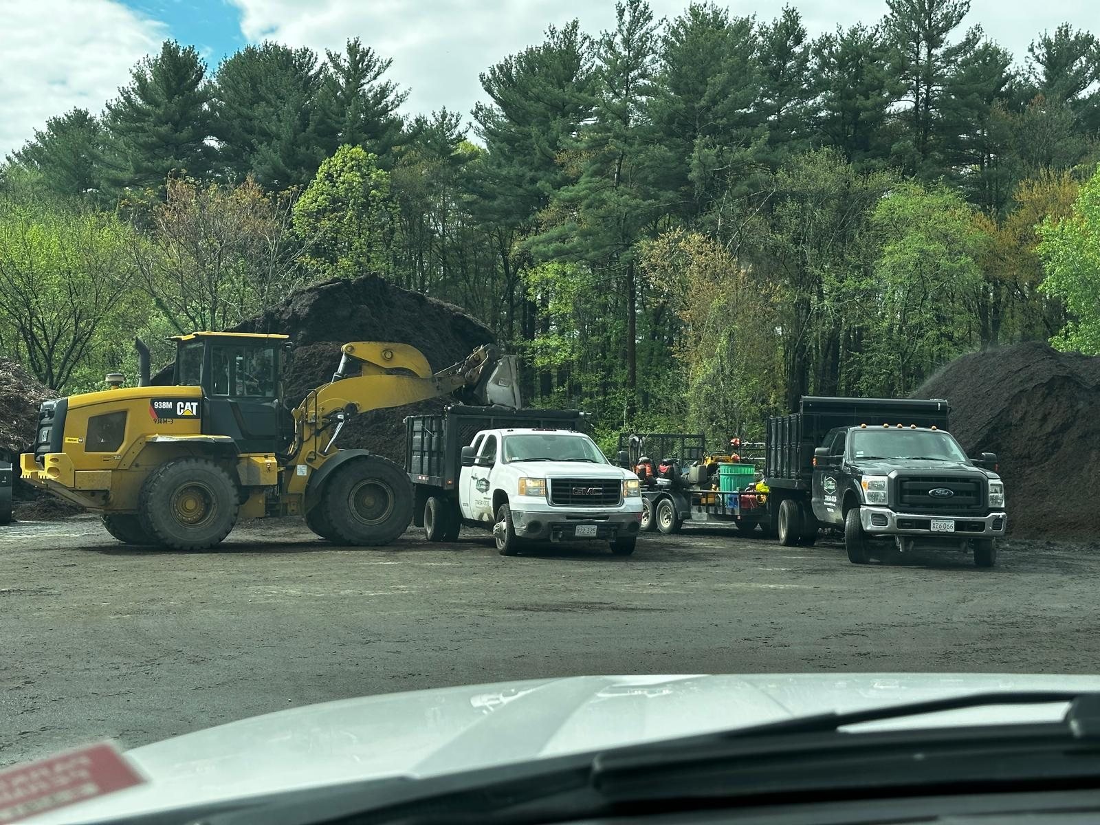 TC PRO trucks and a loader at the yard